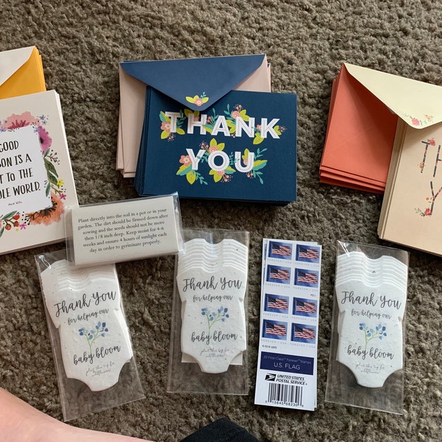 seed paper onesies displayed with thank you notes as gifts with thanks