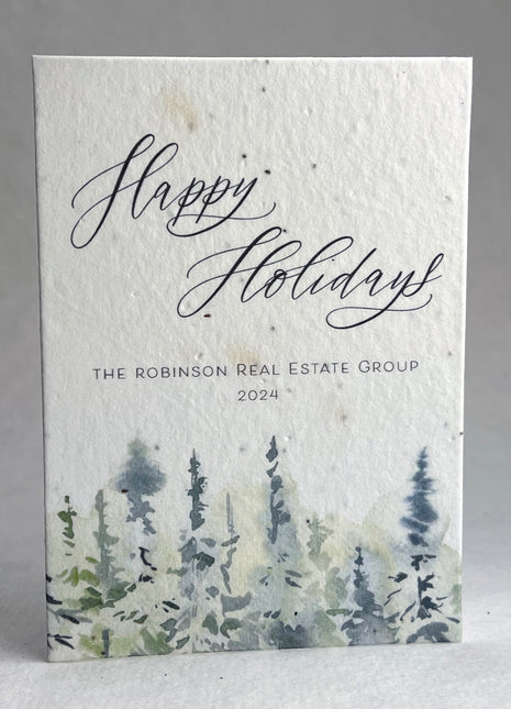 Holiday card with 'Happy Holidays' text and forest design, featuring customized branding.