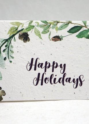 Greeting card with 'Happy Holidays' text and green leaf design on a white background