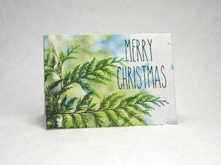 Christmas card with green leaf design and 'Merry Christmas' text on a white background