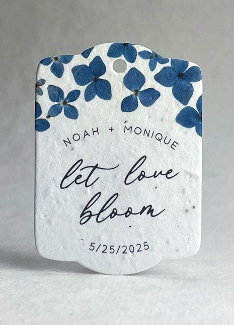 Decorative wedding favor with blue floral design and text on a white background