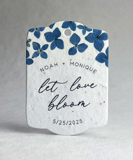 Decorative wedding favor with blue floral design and text on a white background
