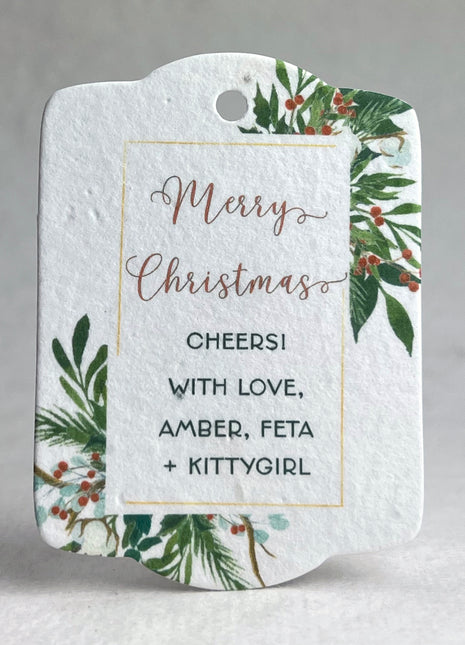 Christmas-themed gift tag with festive design and personalized text on a gray background