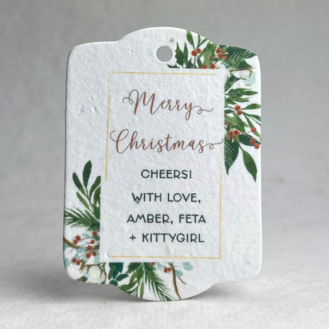 Christmas-themed gift tag with festive design and personalized text on a gray background
