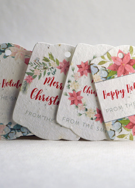 Set of floral gift tags with personalized text on a white surface