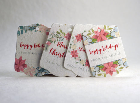 Set of floral gift tags with personalized text on a white surface