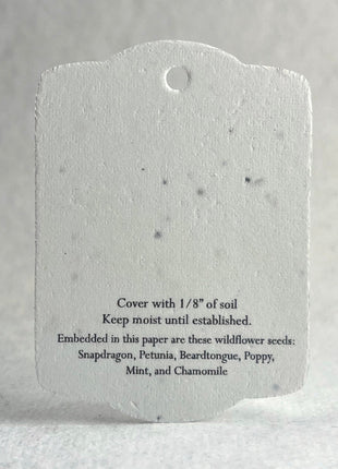 Seed paper tag with text on a gray background